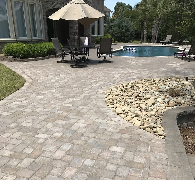 Stone patio and path around pool